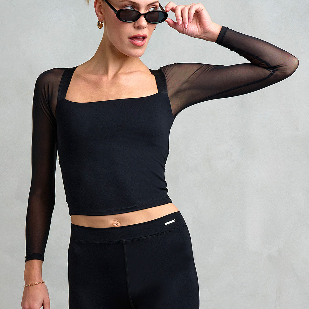 Our model is wearing the Belgravia mesh sleeve top with keyhole back. Luxury, sustainably made activewear from Stretch Studio London.