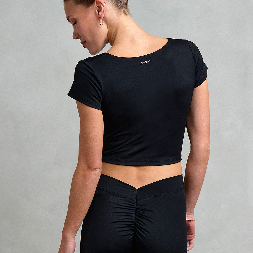 Back view of the Westminster Gathered Cap Sleeve Top from Stretch Studio London, featuring metal logo tab to back of neck. 